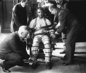 black man strapped to an electric chair